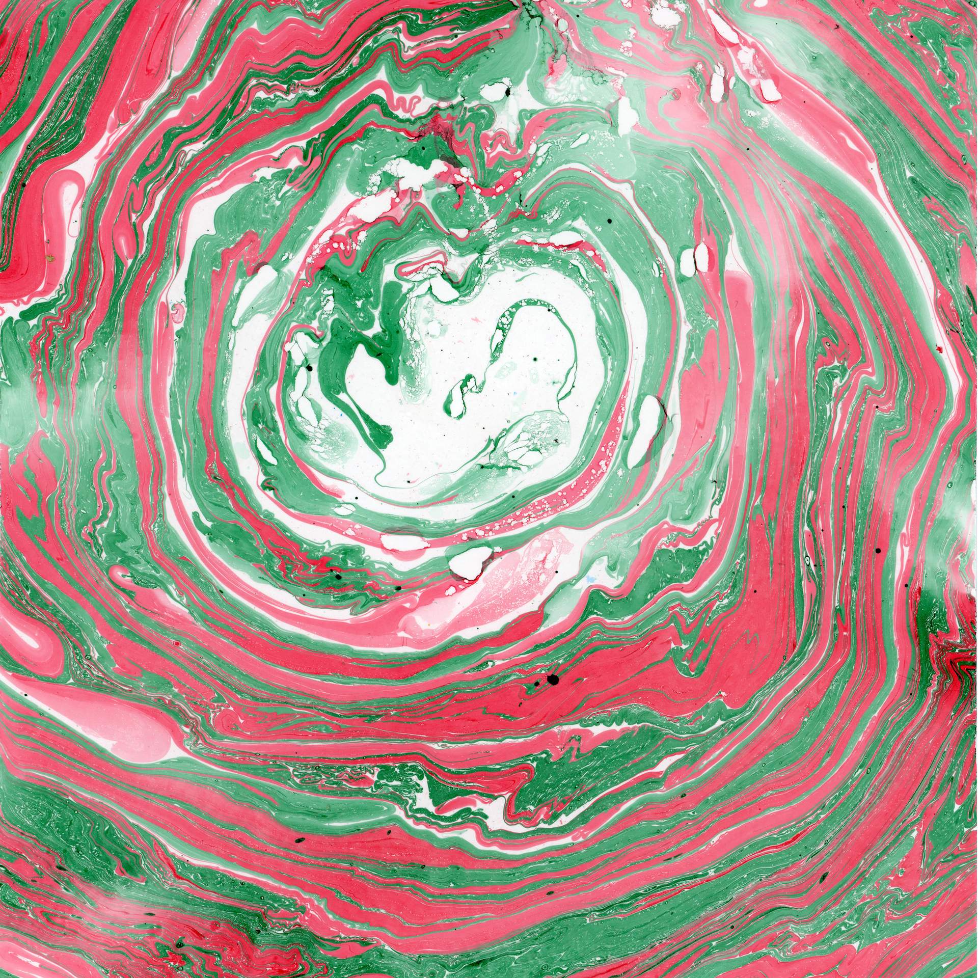 A swirl of marbled red and green inks on a square sheet of watercolour paper can be seen. The swirls of colour rotate in a circular fashion towards the centre of the paper, suggesting that we are looking into the eye of a storm.