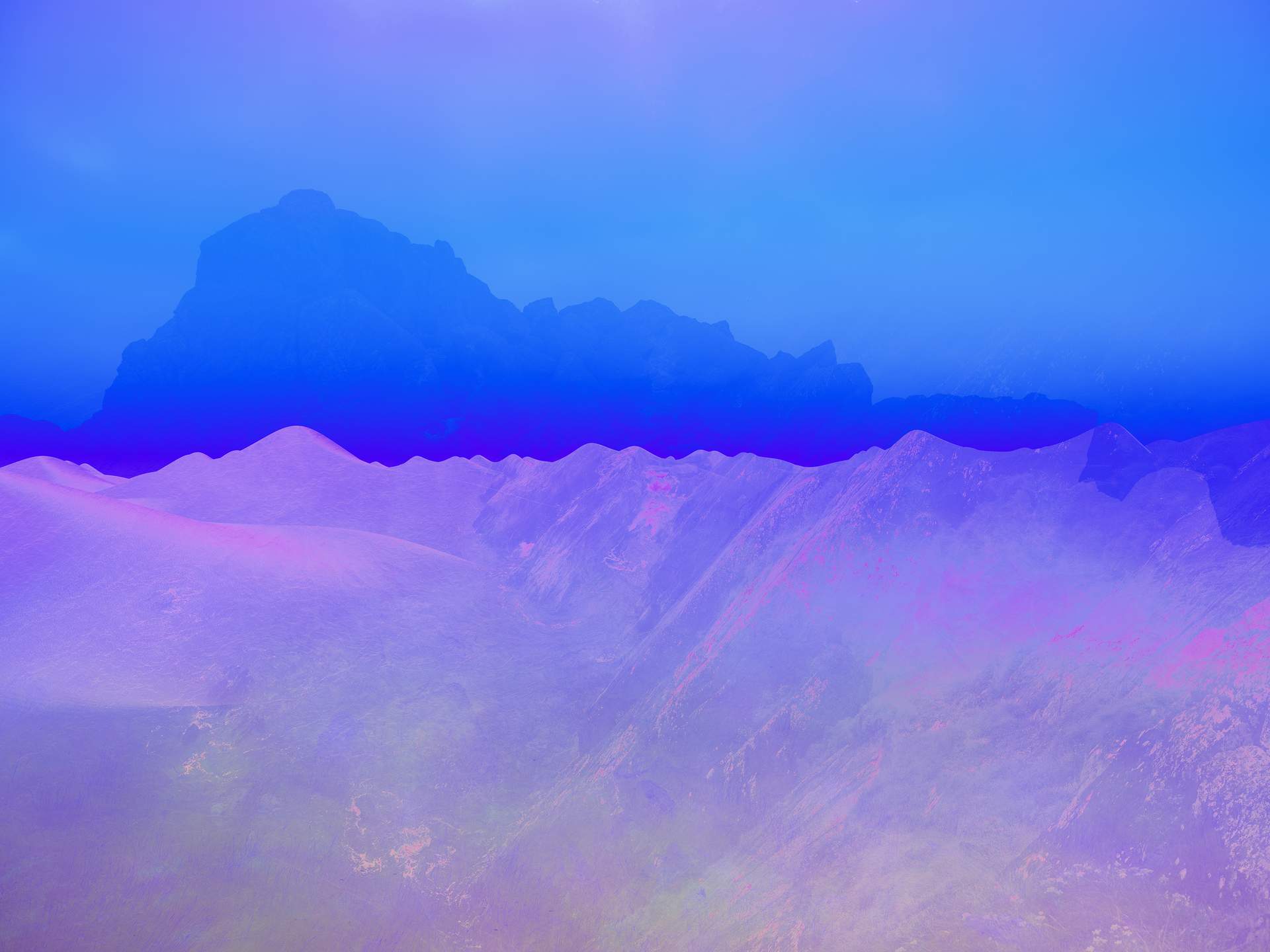 A digital collage of multiple images layered on top of each other. There are sand dunes in the distance, and layered over these is an image of giant rocks standing on top of a hill. The image is made up of purple and blue colours, and appears somewhat dreamy.