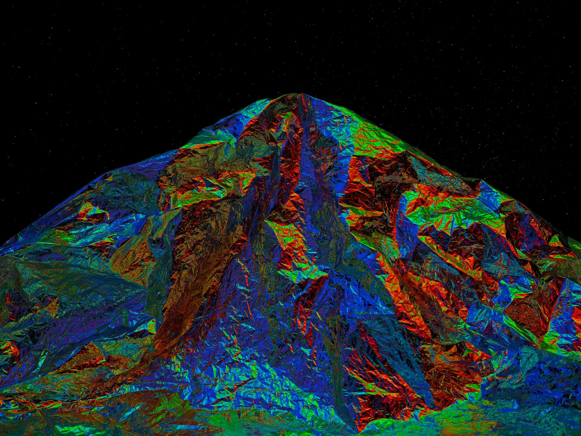 An image of a multi-coloured metallic-looking mountain, set against a starry night sky.