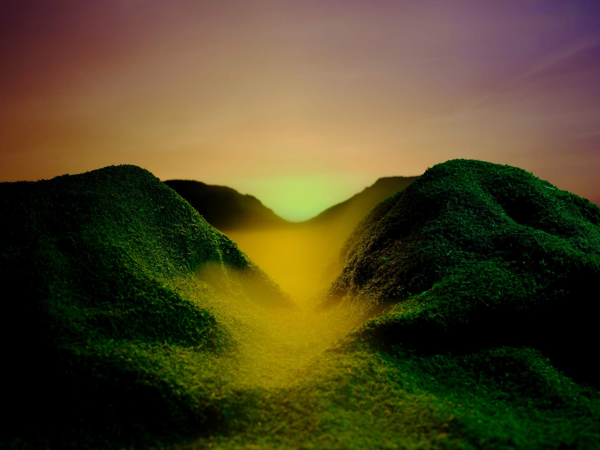 An image of a lush green valley with yellow mist at its centre, set against a sunset gradient of yellow to purple.
