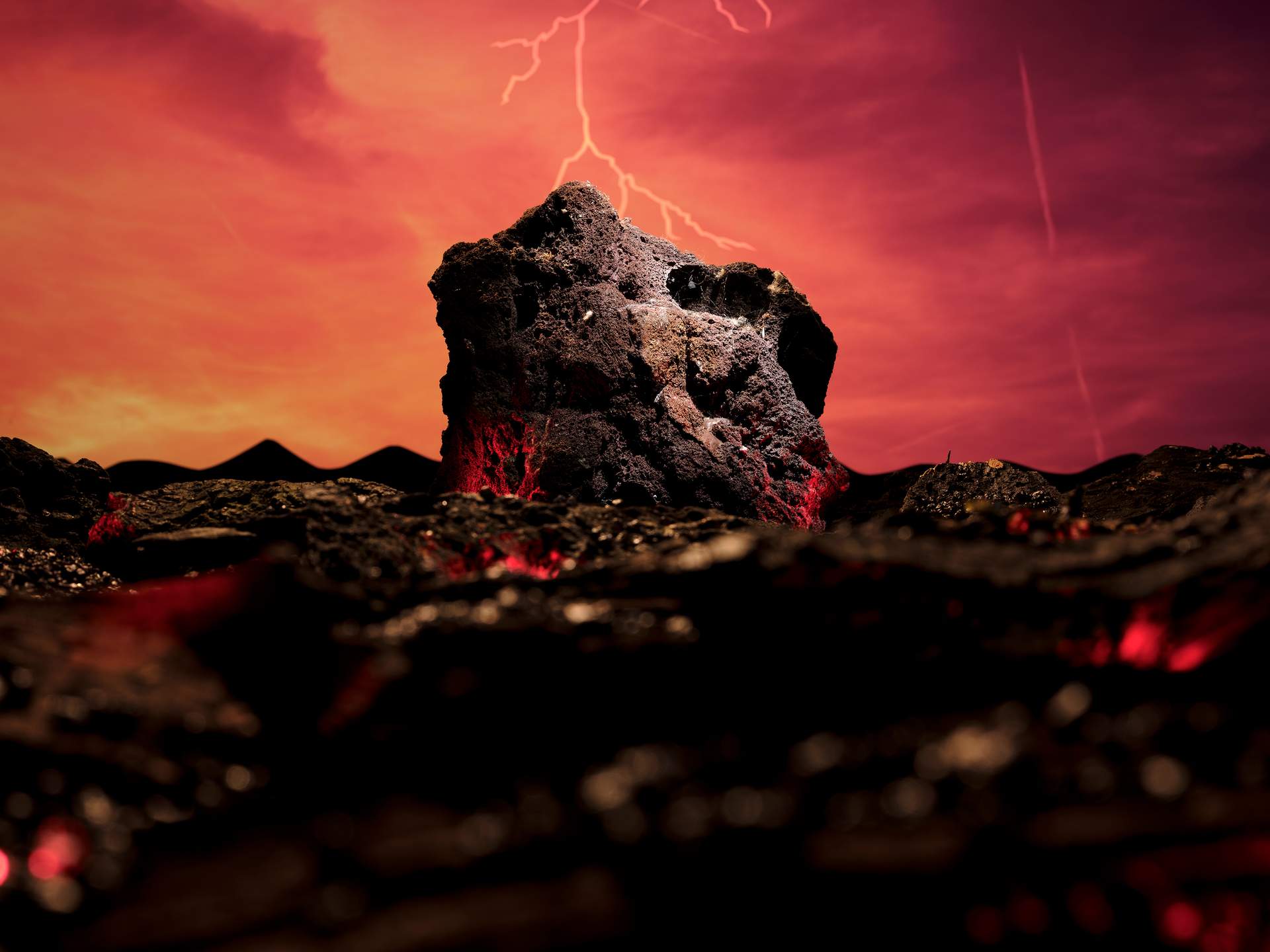 An image of a giant meteorite on a barren, lava-filled landscape. Mountains can be seen in the distance, set against a deep red and yellow sky with lightning.